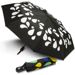 A compact umbrella with a black canopy featuring white droplet patterns and a multicoloured case.