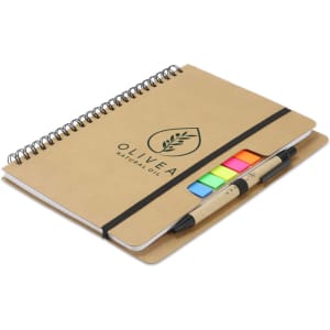 A kraft notebook with a spiral binding, featuring coloured sticky flags and two pens. It has a logo on the cover.