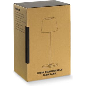A cardboard box containing an Ember Rechargeable Table Lamp, featuring a simple design and a printed outline of the lamp.