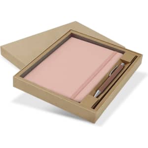 A pink notebook and silver pen set displayed in a brown gift box. The packaging is sleek and minimalistic.