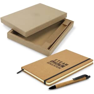A brown cork notebook with an elastic band and a matching pen, presented in a cardboard box.
