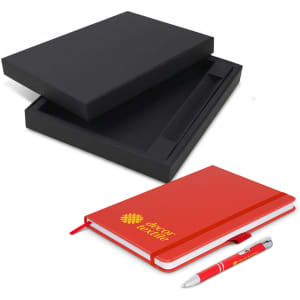 A black gift box contains a red notebook and a silver pen, featuring a logo on the notebook.
