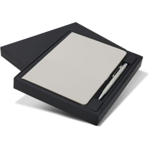 A grey notebook and a silver pen presented in a black gift box. The box is slightly opened to reveal the contents.