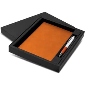 An orange notebook and a pen in a black gift box. The box is partially open, revealing the contents.