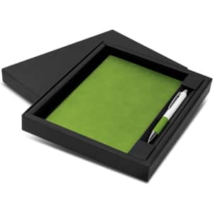 A green notebook and pen set displayed in a black box, featuring a smooth cover and a sleek pen.