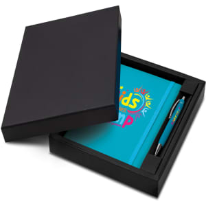 A blue notebook and pen set displayed in a black gift box. The notebook features a logo and the set includes branding on the pen.
