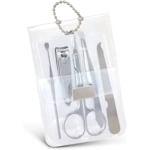 A vinyl manicure set containing silver tools, including scissors, clippers, and a file, packaged in a clear holder.