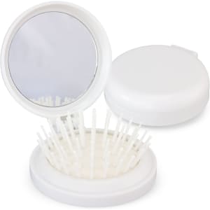 A compact brush with a mirror, featuring white bristles and a round white casing, partially open.