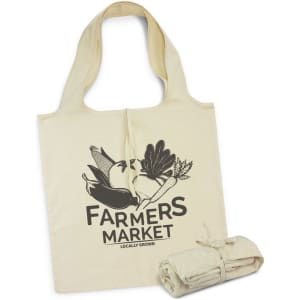 A natural-coloured foldaway tote bag featuring a black design with a farmers market theme and a logo.
