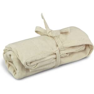A folded beige tote bag, secured with a tied string, showcasing a simple, natural fabric design.