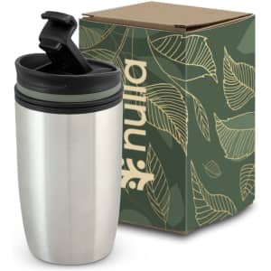 A stainless steel double wall cup with a black lid, displayed next to a leafy patterned box.