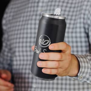 A drink bottle in matte black with a silver lid and a logo on the front, held in a person's hand.