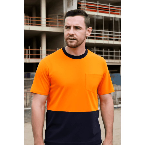 An orange and navy crew neck cotton T-shirt with a pocket, worn by a man on a construction site.