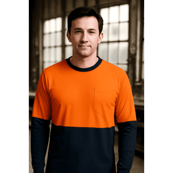 Long-sleeve crew neck t-shirt in bright orange and navy blue, featuring a pocket, displayed against an industrial background.