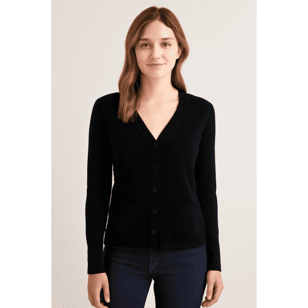 A knitted cardigan in black, featuring a V-neck, button front, and a pocket, worn by a model.