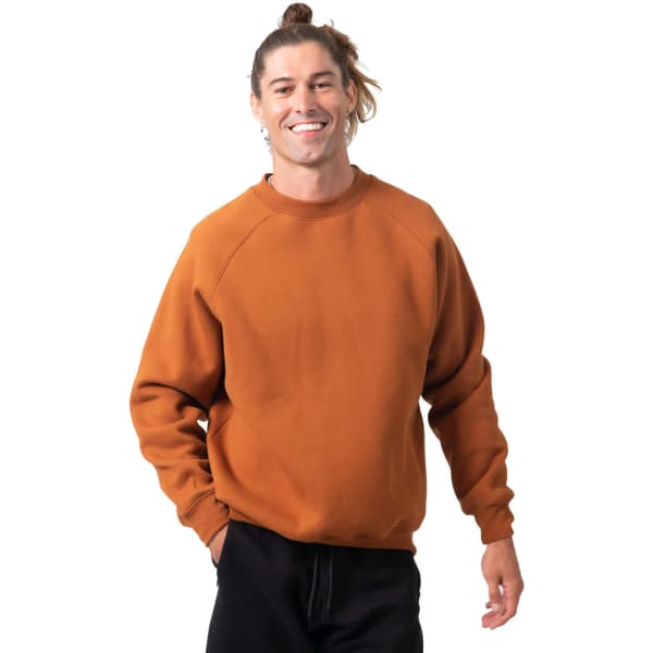 An adult man smiles while wearing a rust-coloured cotton sweatshirt with a logo.
