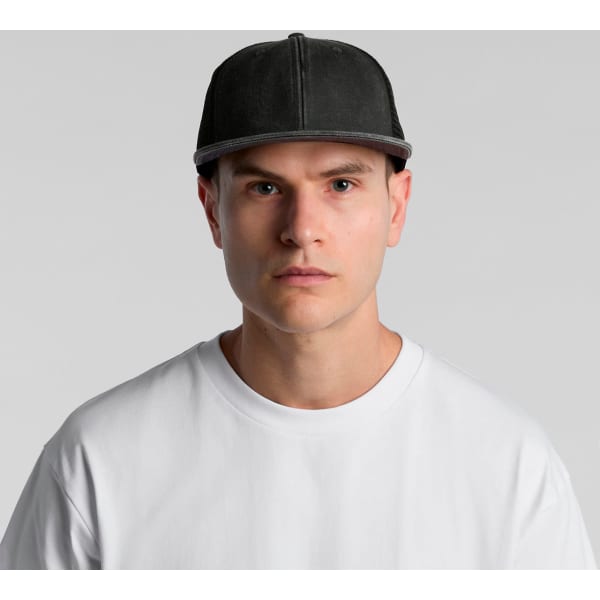 A grey trucker cap with a structured front and mesh back, worn by a model in a white t-shirt.