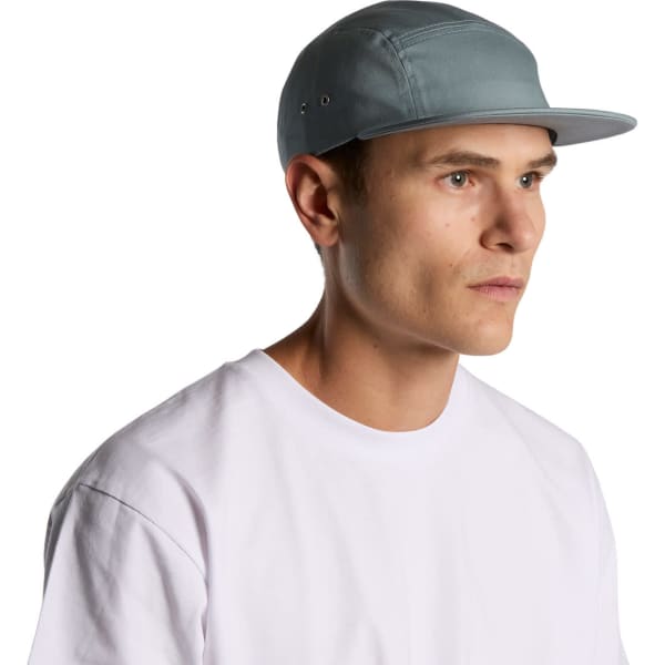 A five-panel cap in light blue worn by a person facing sideways, showcasing its design and fit.