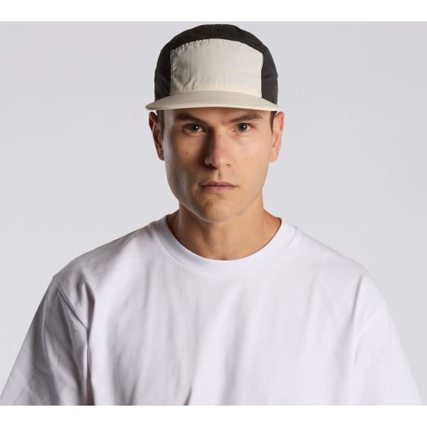 A two-tone nylon cap featuring a light-coloured front panel and a black back, with a logo on the front.