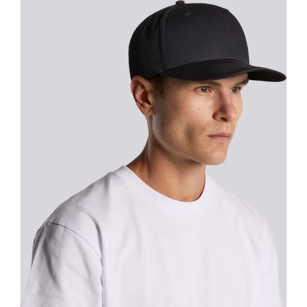 A black cap with a structured design, featuring a curved brim and a logo on the front, worn by a young man.