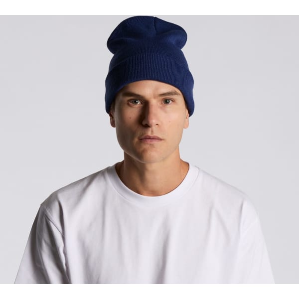 A navy cuff beanie worn by a model, featuring a relaxed fit and a simple design.