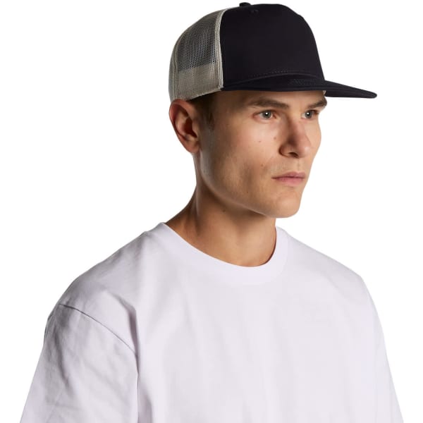 A navy trucker cap with a contrasting beige mesh back, modelled by a man wearing a white t-shirt.