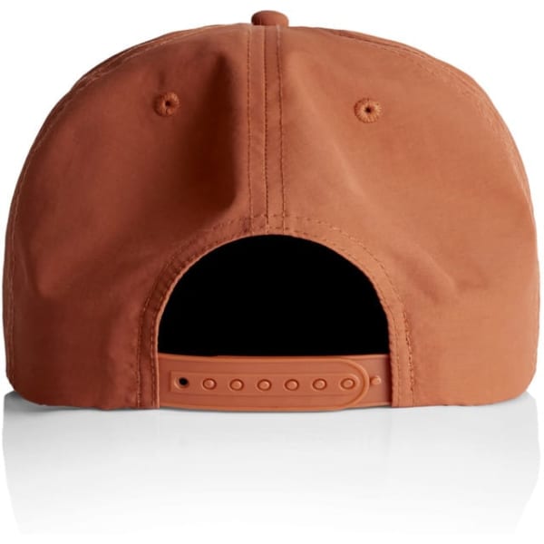 A rust-coloured cap with an adjustable strap and a logo on the back. The cap features a flat brim design.