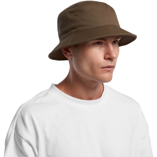 A brown bucket hat with a wide brim, worn by a man in a plain white t-shirt. The hat features ventilation holes.
