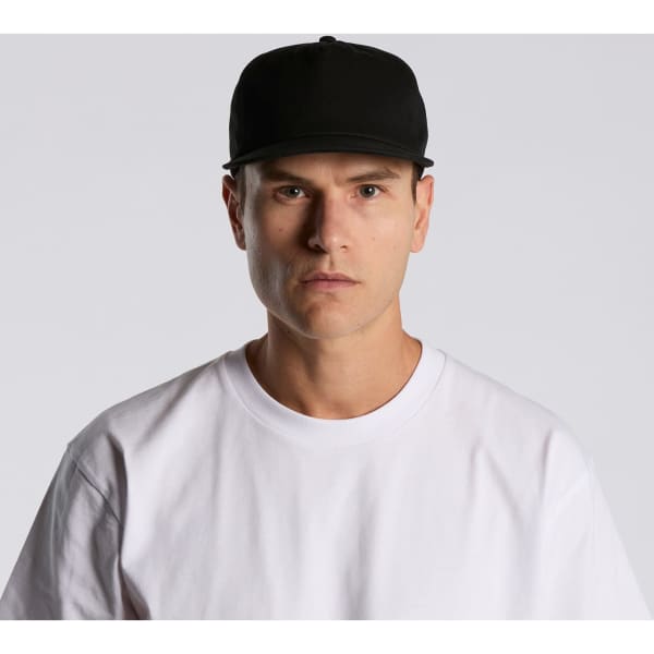 A black cap featuring a structured design, worn by a model in a white t-shirt, with a logo on the front.