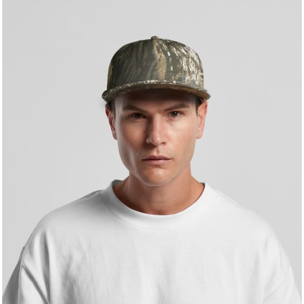 A camo cap featuring a green and brown pattern, worn by a model in a white shirt, with a visible logo.