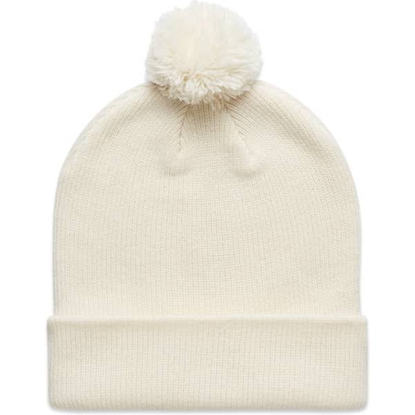 A cream-coloured beanie with a fluffy pom-pom on top, featuring a rolled cuff and a logo.