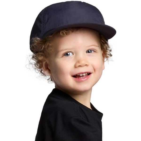 A navy cap designed for kids, featuring a curved brim and a logo on the side, worn by a smiling child.