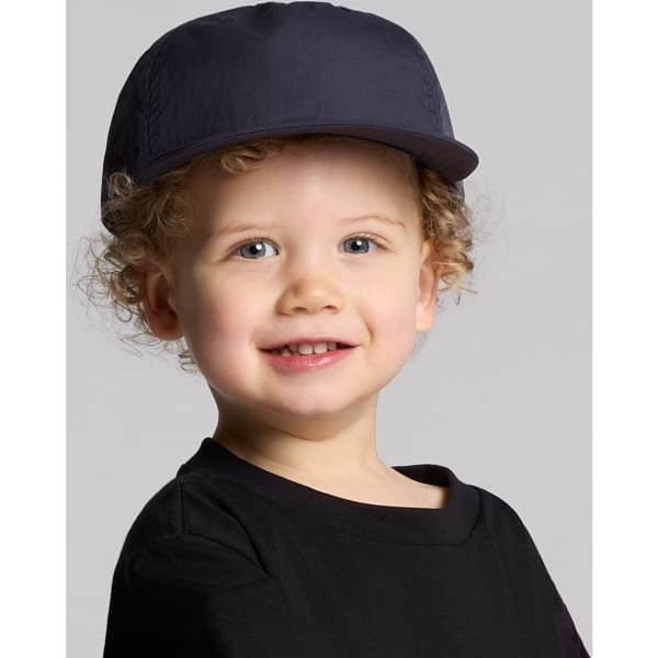 A navy cap for kids with a rounded crown and a stiff peak, featuring a logo on the front.