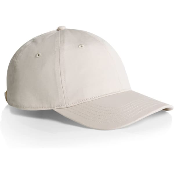 A beige cap with a curved brim and stitching details. It features a logo on the side.