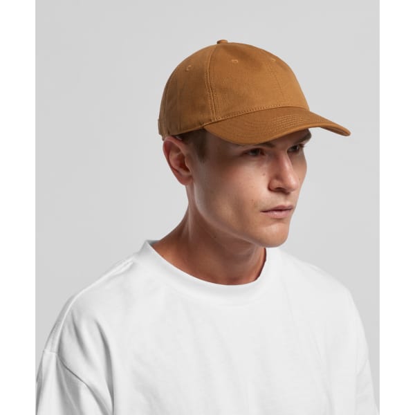 A brown cap with a curved brim and an adjustable strap, worn by a model in a white T-shirt.