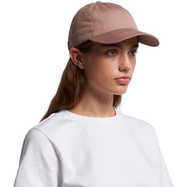 A pink cap with a rounded peak, featuring a logo on the side. The model wears a white t-shirt.