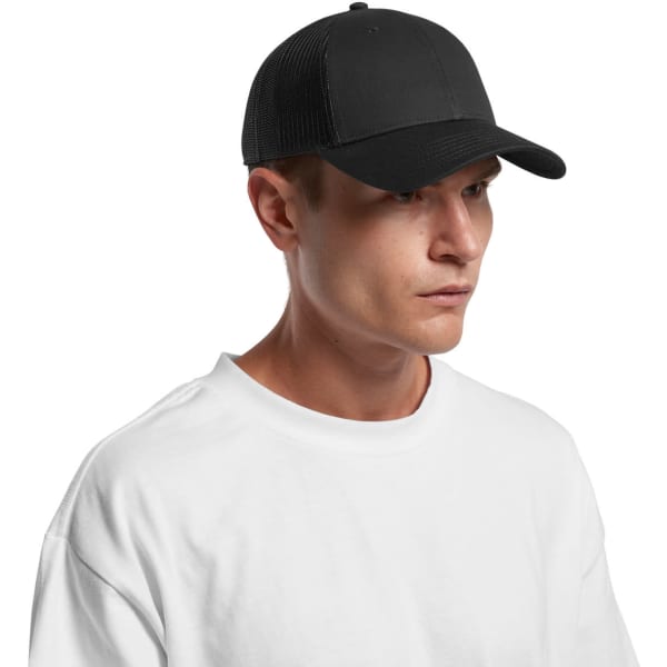 A black trucker cap with a mesh back, worn by a person in a white t-shirt. The cap features a logo.