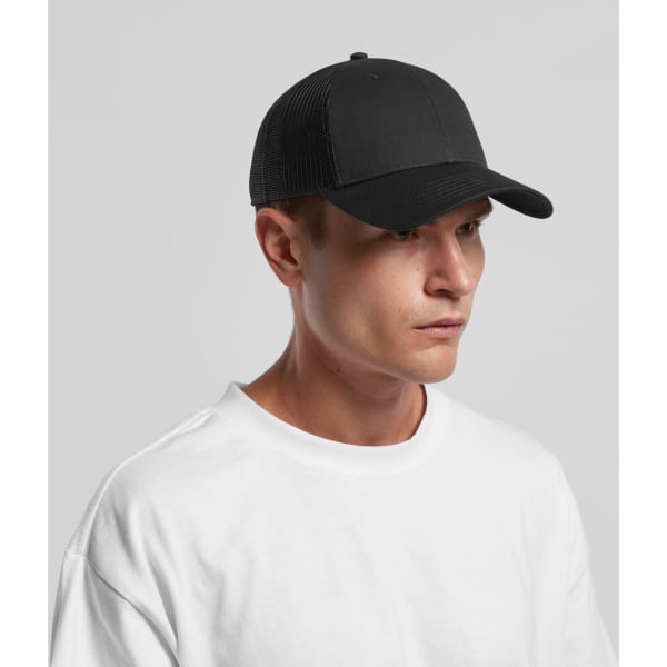 A black trucker cap with a mesh back, featuring a logo on the front, worn by a person in a white t-shirt.