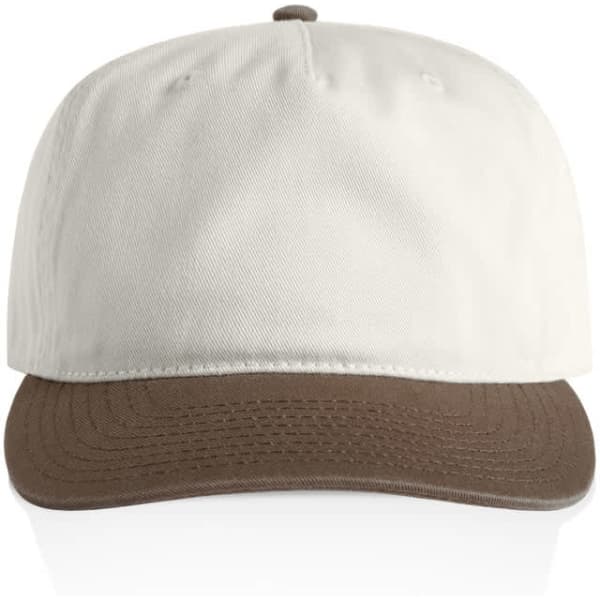 A two-tone cap featuring a cream upper and a brown brim. The cap includes a logo on the front.