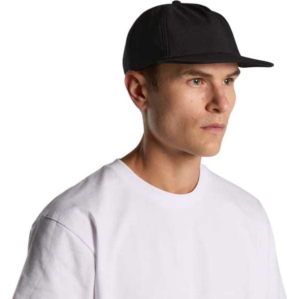 A black cap with a flat brim worn by a person in a white t-shirt. The cap features a logo.
