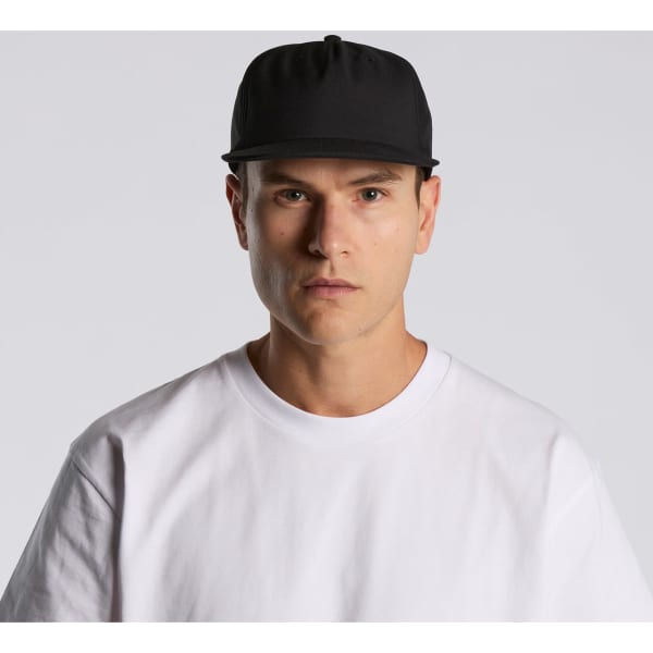 A black cap is worn by a model in a white shirt, featuring a logo on the front.