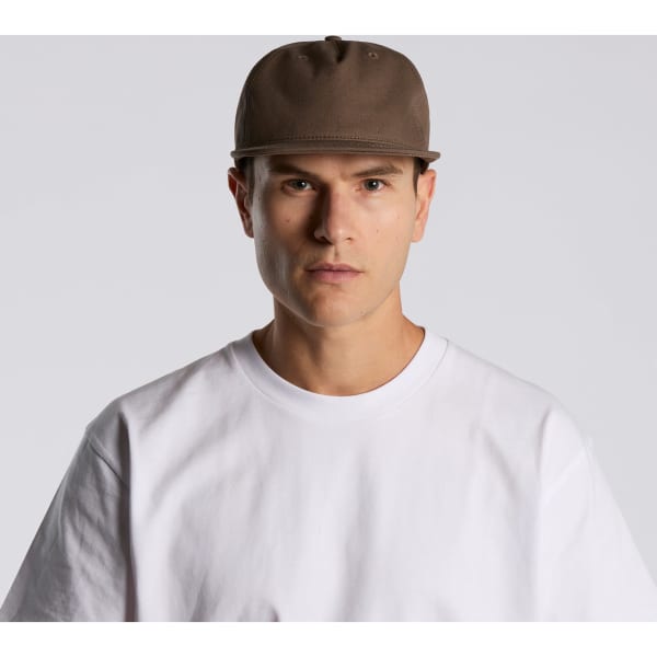 A brown cap with a structured design, featuring a logo, worn by a model in a white t-shirt.