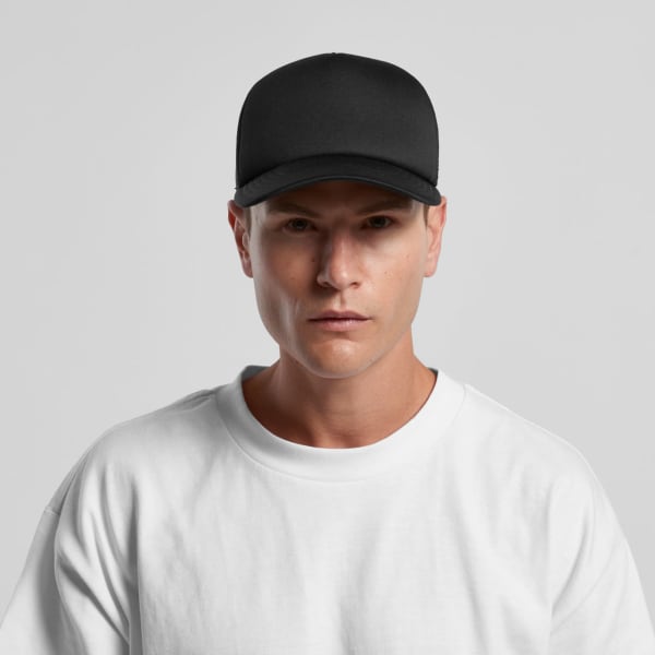 A black Frame Foam Trucker Cap with a structured front and a logo, worn by a model in a white t-shirt.