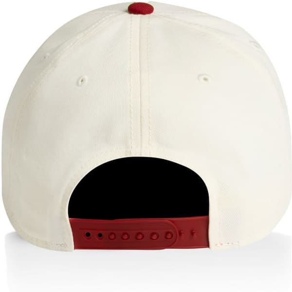 A two-tone cap in cream and burgundy with a rear adjuster and a logo.