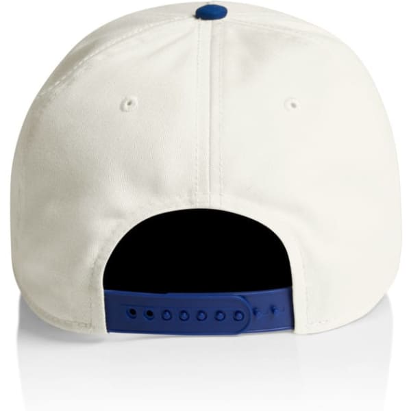 A two-tone cap featuring a cream exterior and a navy blue underside. It includes an adjustable strap and has a logo.
