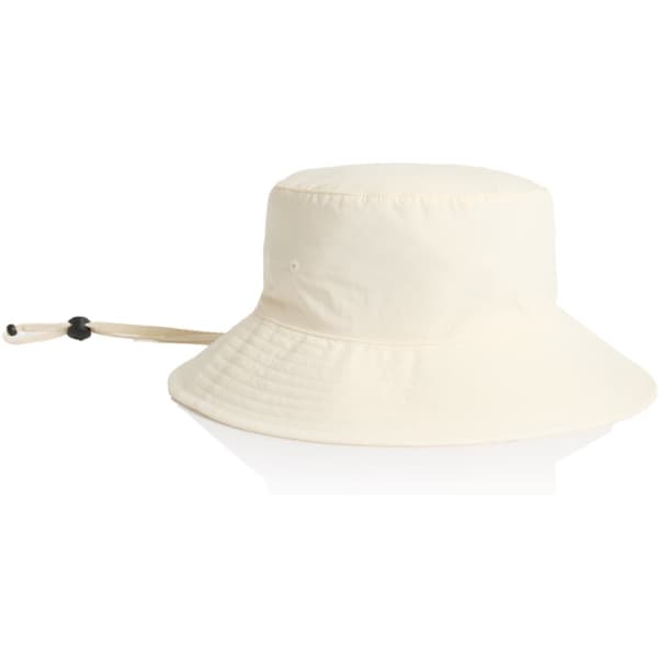 A cream nylon wide brim bucket hat with an adjustable chin strap and a rounded top.