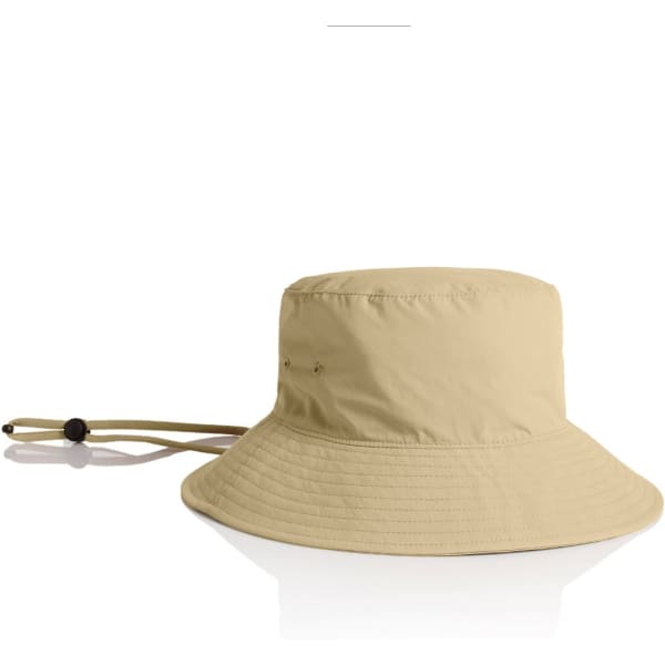 A beige nylon wide brim bucket hat with a corded chin strap and an attached logo.