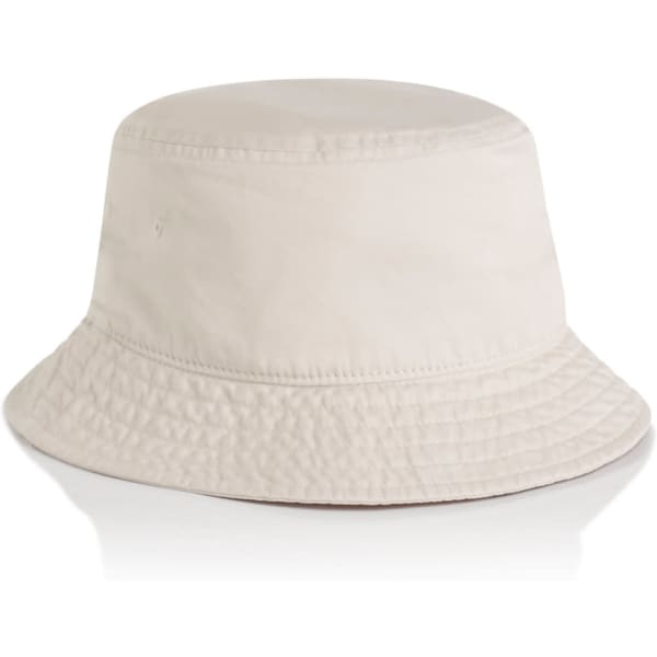 A faded cream bucket hat featuring a textured appearance and a wide brim. It has a branding logo on the side.
