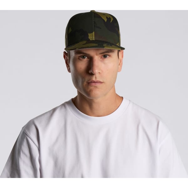 A camouflage cap featuring various shades of green, worn by a model in a plain white t-shirt.
