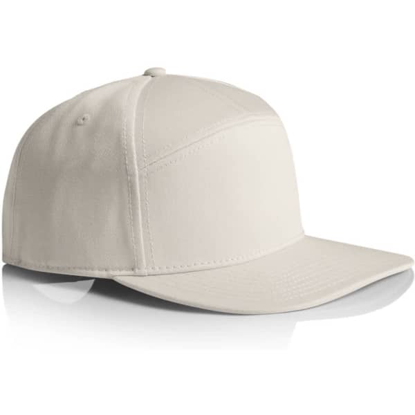 A 7-panel cap in a light cream colour, featuring a structured design and a curved brim. It has a logo on the side.